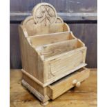 A substantial farmhouse pine letter rack above one drawer, the back panel carved with fruiting