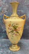 A Royal Worcester two handled pedestal ovoid vase, printed and painted with thistles on a blush