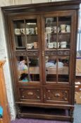 A 20th century oak display cabinet, carved glazed doors, barley twist legs, 183cm high, 106cm