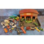 A Timpo wooden garage forecourt; four Dinky petrol pumps & oil dispenser; a Toby Toys no.861