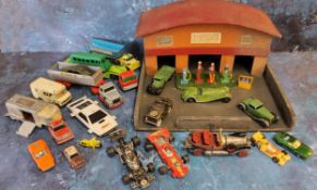 A Timpo wooden garage forecourt; four Dinky petrol pumps & oil dispenser; a Toby Toys no.861