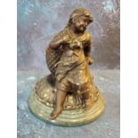 A late Victorian bronze matchstick/spill holder in the form of a young girl sat before a wicker