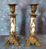 A pair of 19th century French bronze and opaque glass candlesticks, foliate cast sconces, white