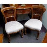 A pair of Victorian mahogany balloon back chairs, stuffed over seats, turned forelegs, c.1860