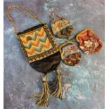 An early 20th century beadwork purse, colourfully worked with stylised flowers, 10cm high, c.
