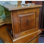 An early 20th century oak ecclesiastical alter cabinet, panelled door, inlaid with a cross, brass