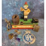 A cast iron mechanical money box titled Trick Dog; a white metal figure of a vagabond; brass