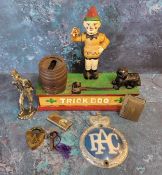 A cast iron mechanical money box titled Trick Dog; a white metal figure of a vagabond; brass