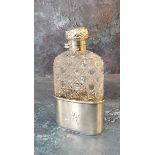 A silver and hobnail cut glass hip flask, detachable cup, hinged domed cover, embossed with scrolls,