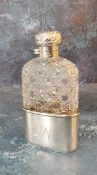 A silver and hobnail cut glass hip flask, detachable cup, hinged domed cover, embossed with scrolls,