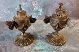 A pair of Regency bronze pastille burners and covers, of pedestal form, butterfly handles, the bases