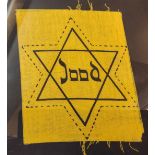A WWII Dutch Jewish patch in the form of the Star of David with the word 'Jood' in the centre,