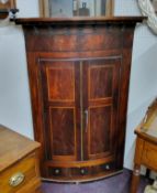 WITHDRAWN - A George III country house bow front  mahogany corner cupboard, barber pole strung