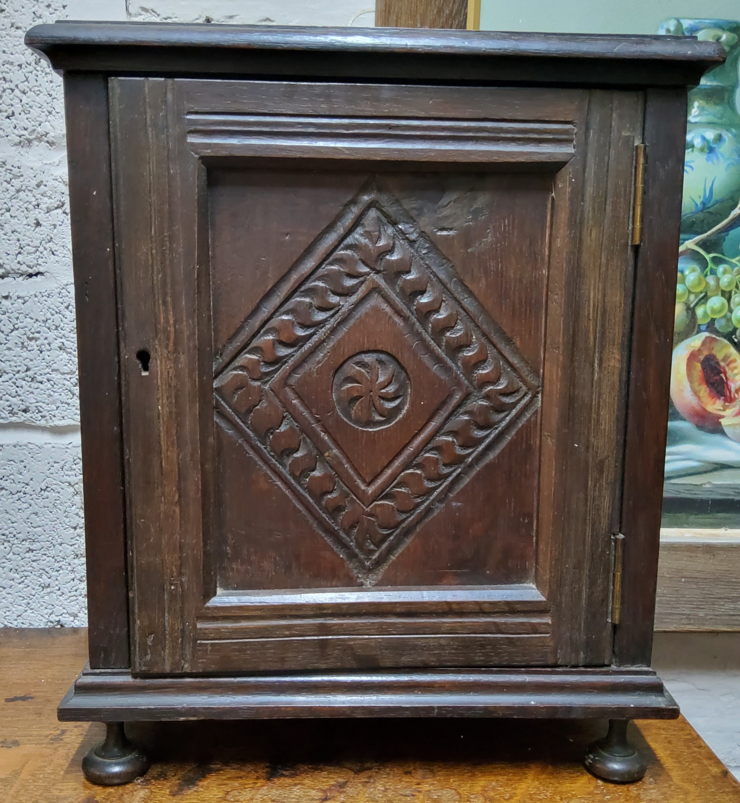 An early 20th century oak table top, smokers cabinet, carved ;lozenge panelled door, fitted - Image 2 of 3