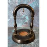 A Victorian ebonised pocket watch stand, the circular base with label From California House