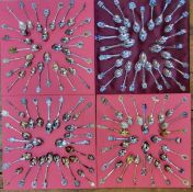 A collection of spoons including sterling silver and enamel examples, arranged on four trays, mainly