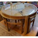 A mid 20th century design Nathan teak circular glass top coffee table,  enclosing three 'oval'