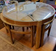 A mid 20th century design Nathan teak circular glass top coffee table,  enclosing three 'oval'