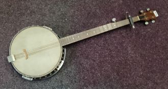 A four string  banjo, the back with  transfer printed eagle with outspread wings,