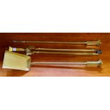 A set of three brass fireside implements and andiron, 70cm long (4)