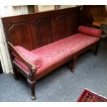 An 18th century oak settle, rectangular back with four  arched raised and fielded panels, shaped