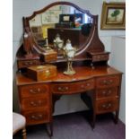 An Edwardian Sheraton Revival satinwood inlaid dressing table, shield shaped mirror, the bow