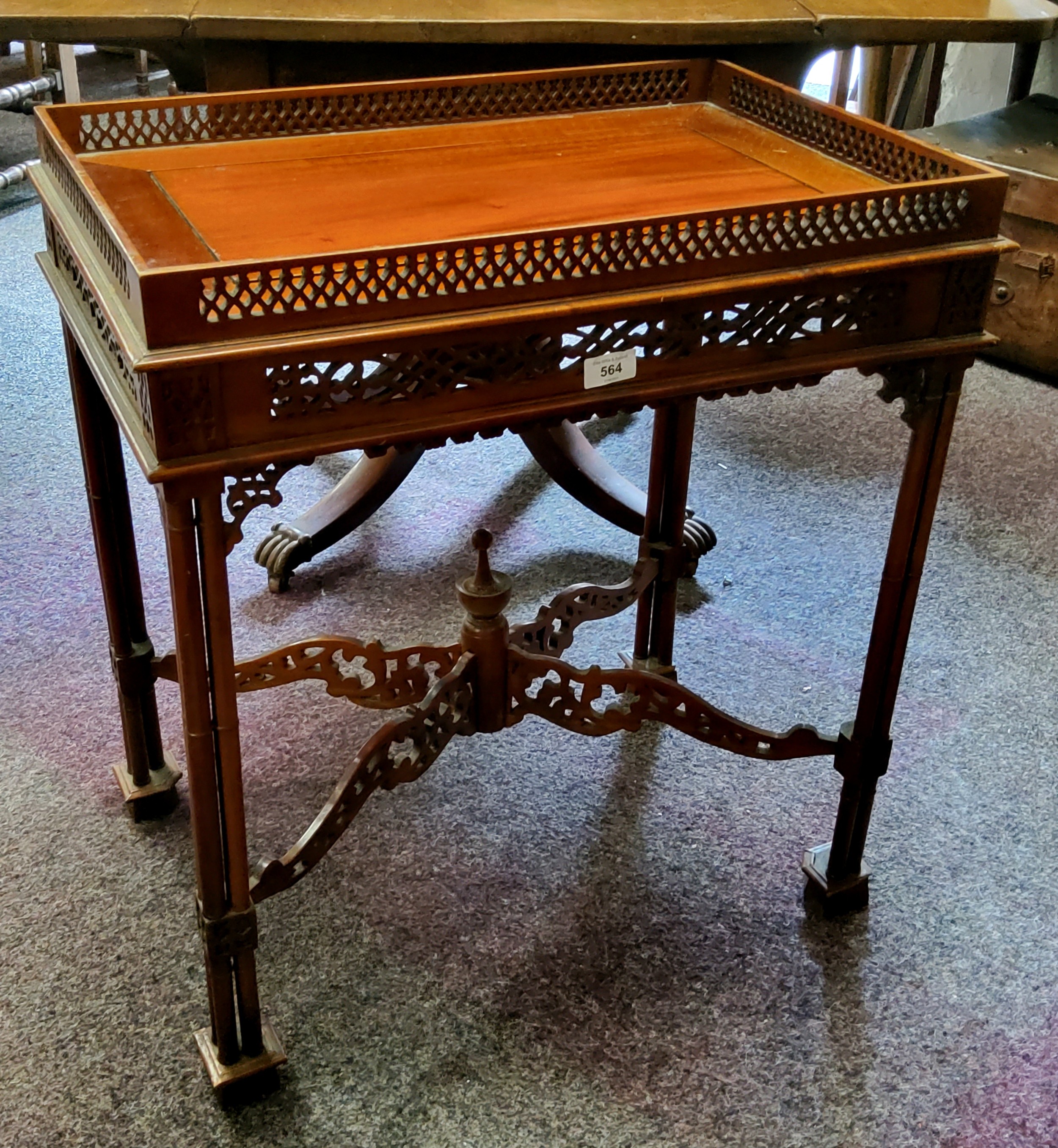 A reproduction mahogany silver table, pierced gallery, triple cluster legs, pierced X stretcher,