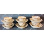 A set of six Newhall tea bowl and saucers, wrythen moulded, decorated in famille rose with