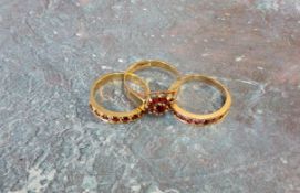 A 9ct gold half eternity ring set with ten round rubies, size O; another set with seven rubies, size