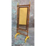 An early 20th century brass doll's house cheval mirror, faux bamboo frame, 25cm high, c.1910