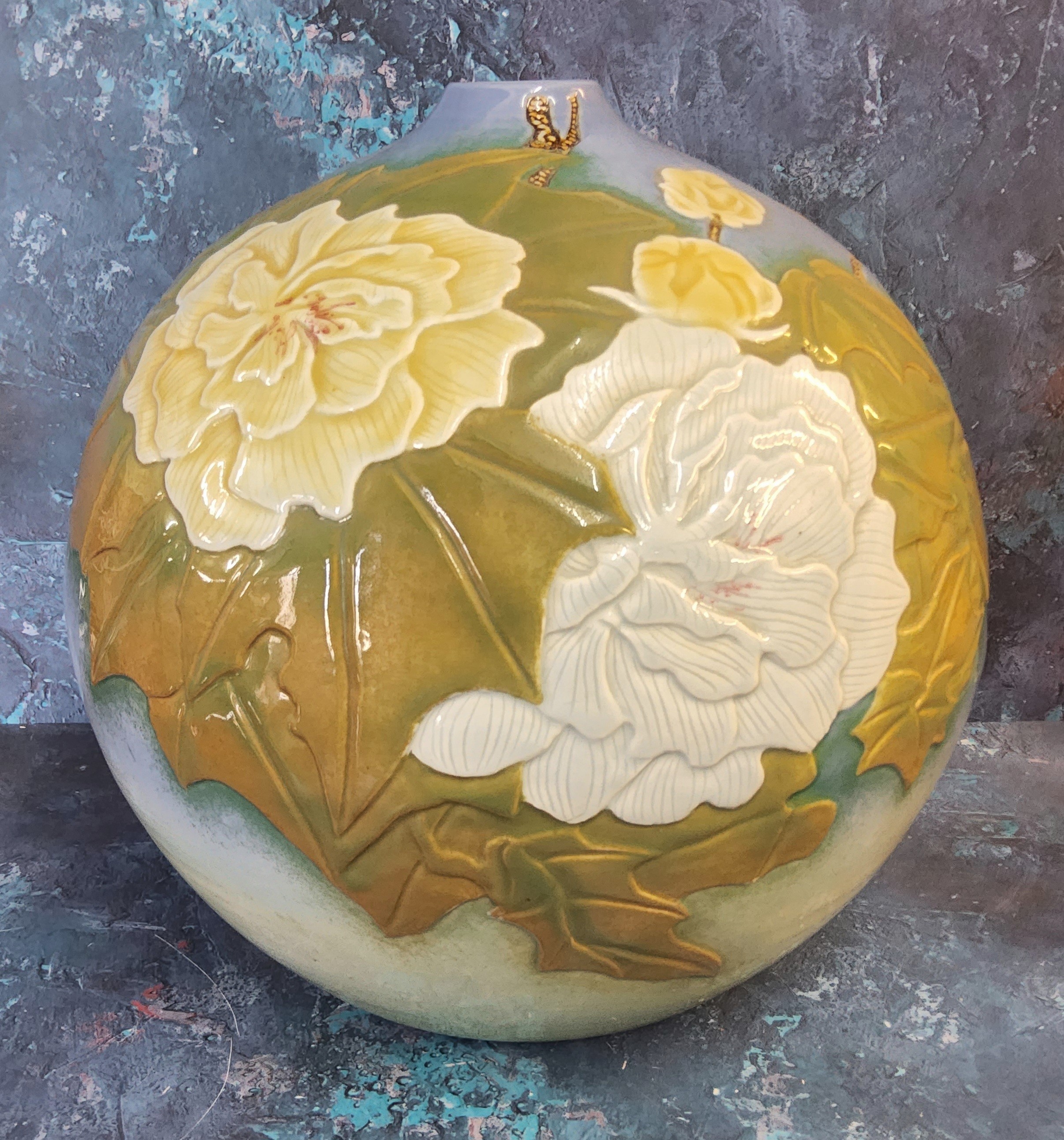 A large Japanese Ikebana ball vase, in relief with large chrysanthemums on a blue ground, 40cm high,