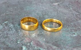 A 22ct gold half barrel band, size N; another size K 8.2g total (2)