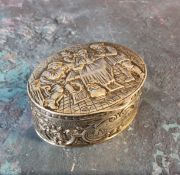 A 19th century Dutch silver oval box, embossed with tavern scene, the sides with scrolls, 2.75cn