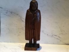 A 19th century hardwood carving, of a bearded man, wearing a hood cloak, 41cm high, c.1880