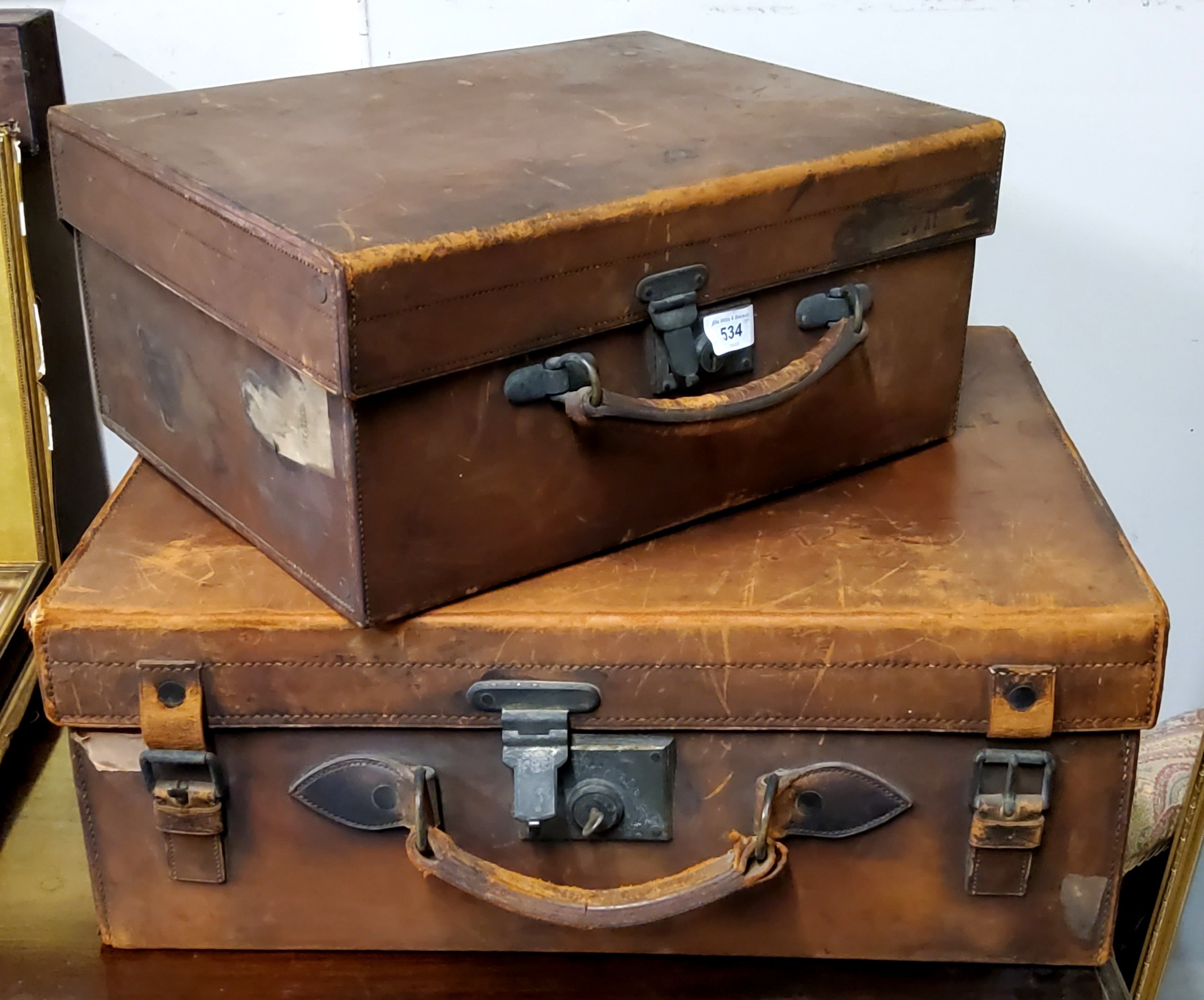 A mid 20th century rectangular leather suitcase, 57cm wide, 44cm deep;  another, smaller, 43cm wide,