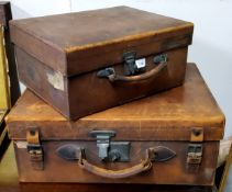 A mid 20th century rectangular leather suitcase, 57cm wide, 44cm deep;  another, smaller, 43cm wide,