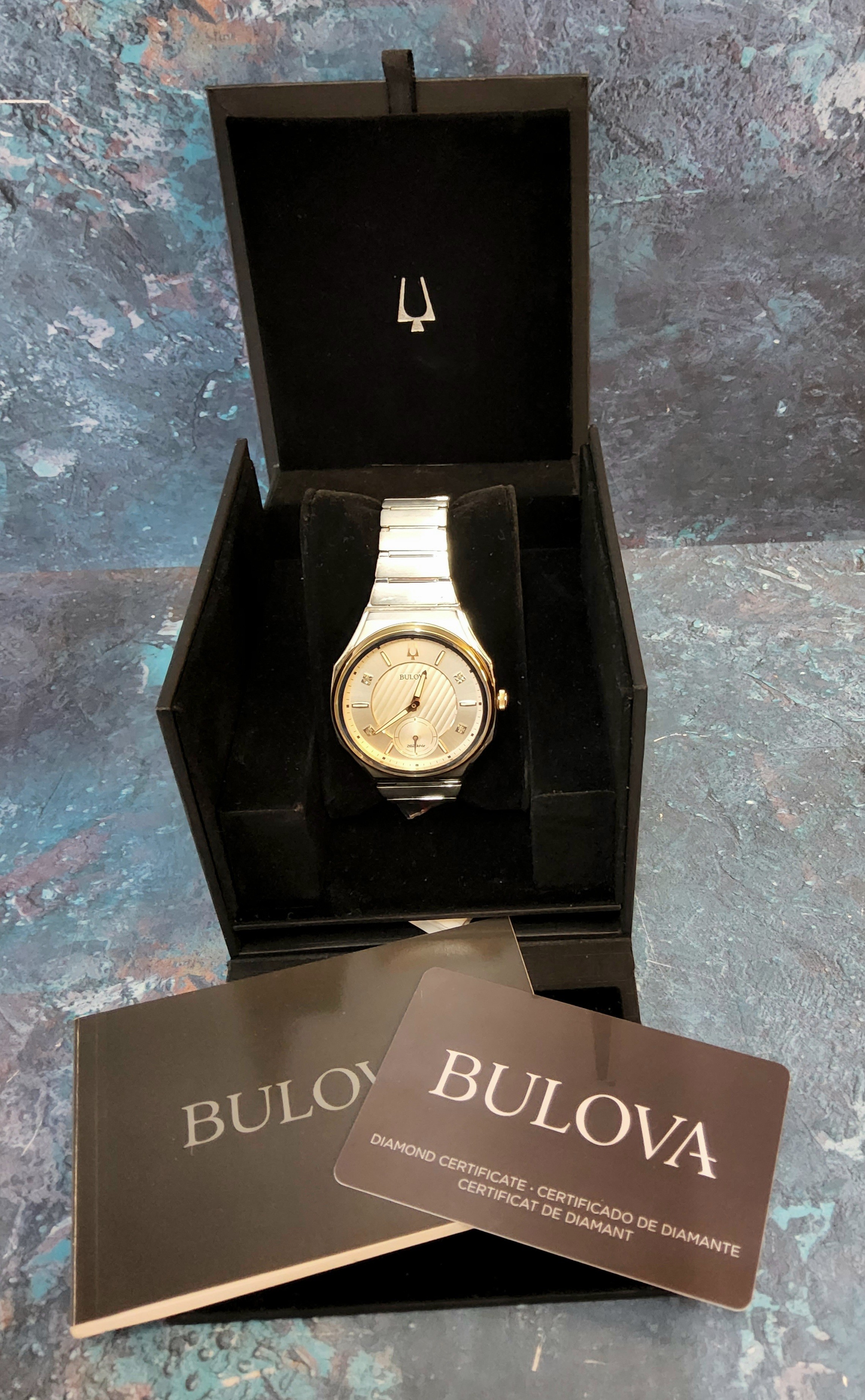 A Bulova Curv stainless steel watch, 262 khz quartz six jewel movement, rose gold plated bezel,