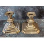 A pair of Continental silver coloured metal  candlesticks, canted sqare sconces, spreading bases,