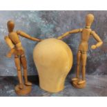 A pair of artist's jointed mannequins approx. 30cms high; a turned solid wood head (3)