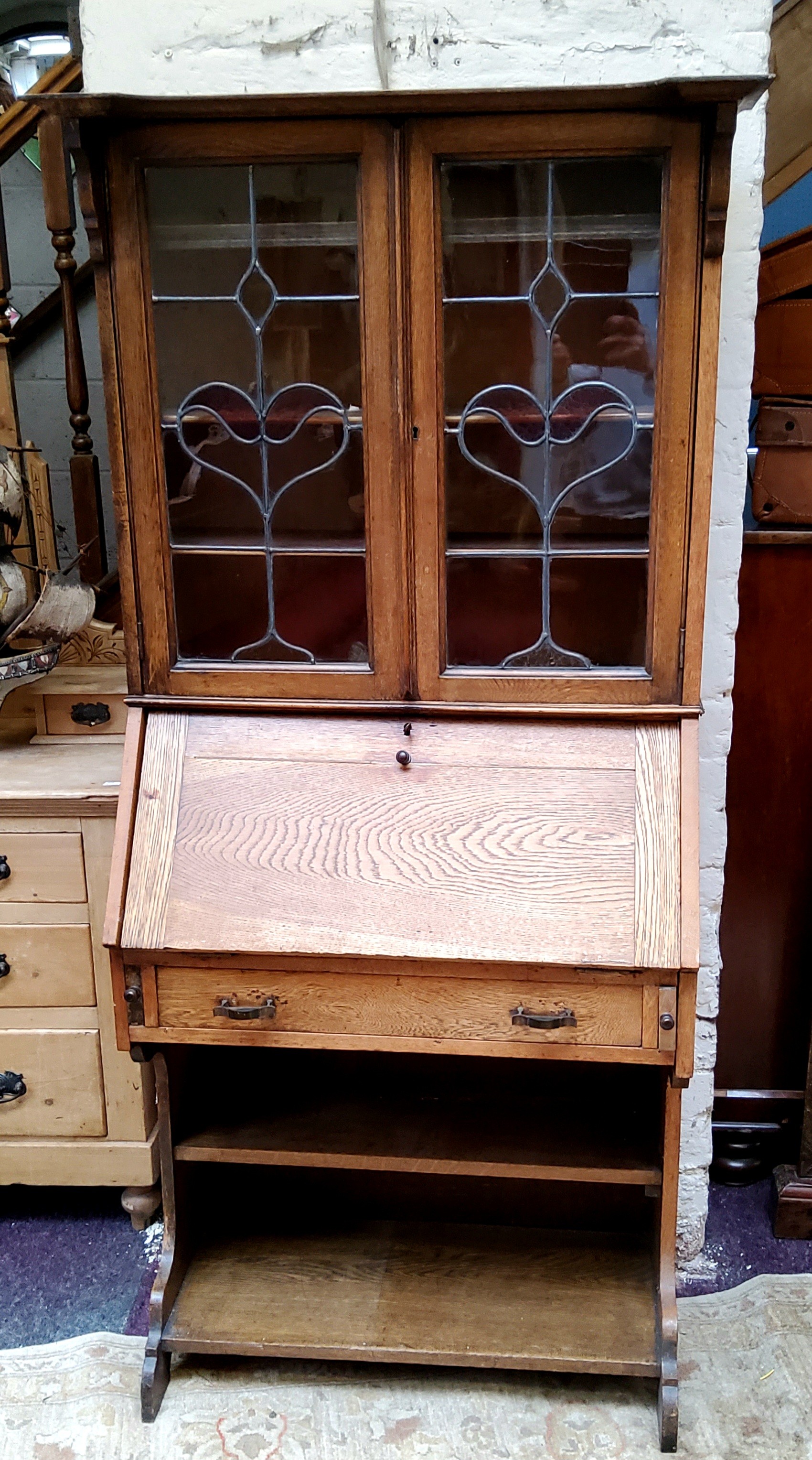 An Arts & Crafts oak bureau bookcase with oversailing cornice, sinuous stained glass leaded panel - Image 2 of 2