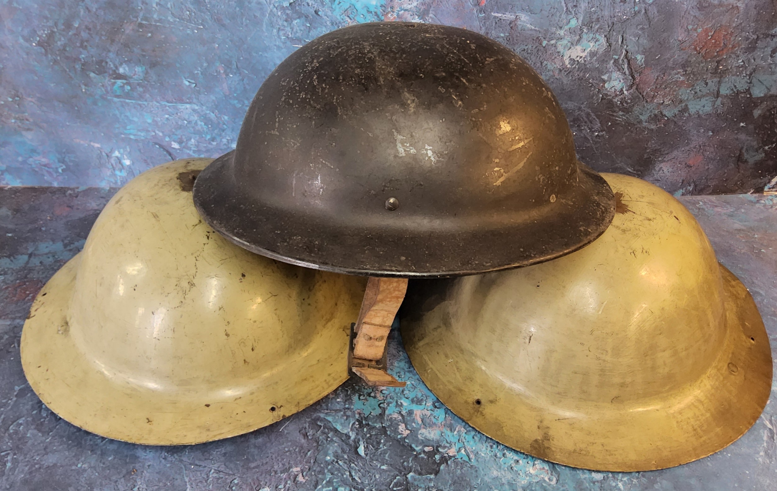A World War II Plasfort helmet;  others, tin (3)
