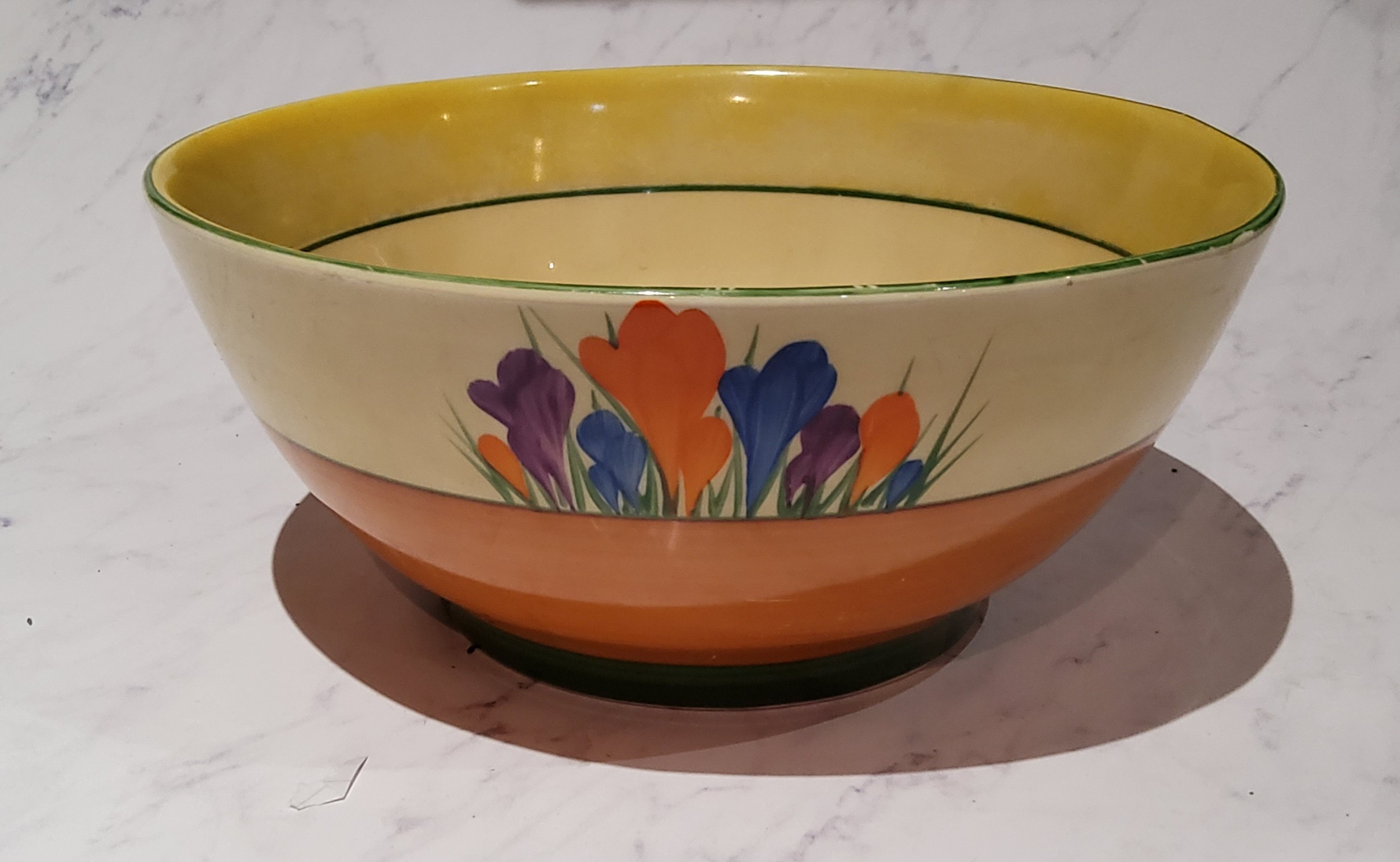 A Clarice Cliff Crocus pattern bowl, typically painted with flowers, banded in tan and green, 18.5cm