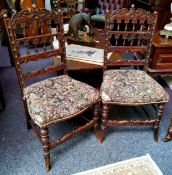 A pair of early 19th century carved oak hall chairs,  with Aubusson tapestry type upholstery c.1830