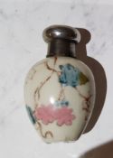 A Victorian porcelain egg shaped scent bottle, decorated with foliage, silver cover, 5.5cm high, c.