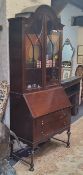 An early 20th century Queen Anne style bureau bookcase