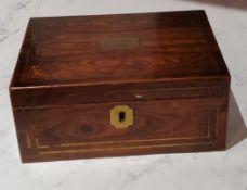 A Regency rosewood rectangular work box, inlaid with brass cartouche and stringing, fitted interior,