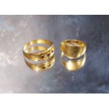 An 18ct gold 'pinkie' signet ring, size I 1/2, 2.7g; a late Victorian 15ct gold ring, set with three