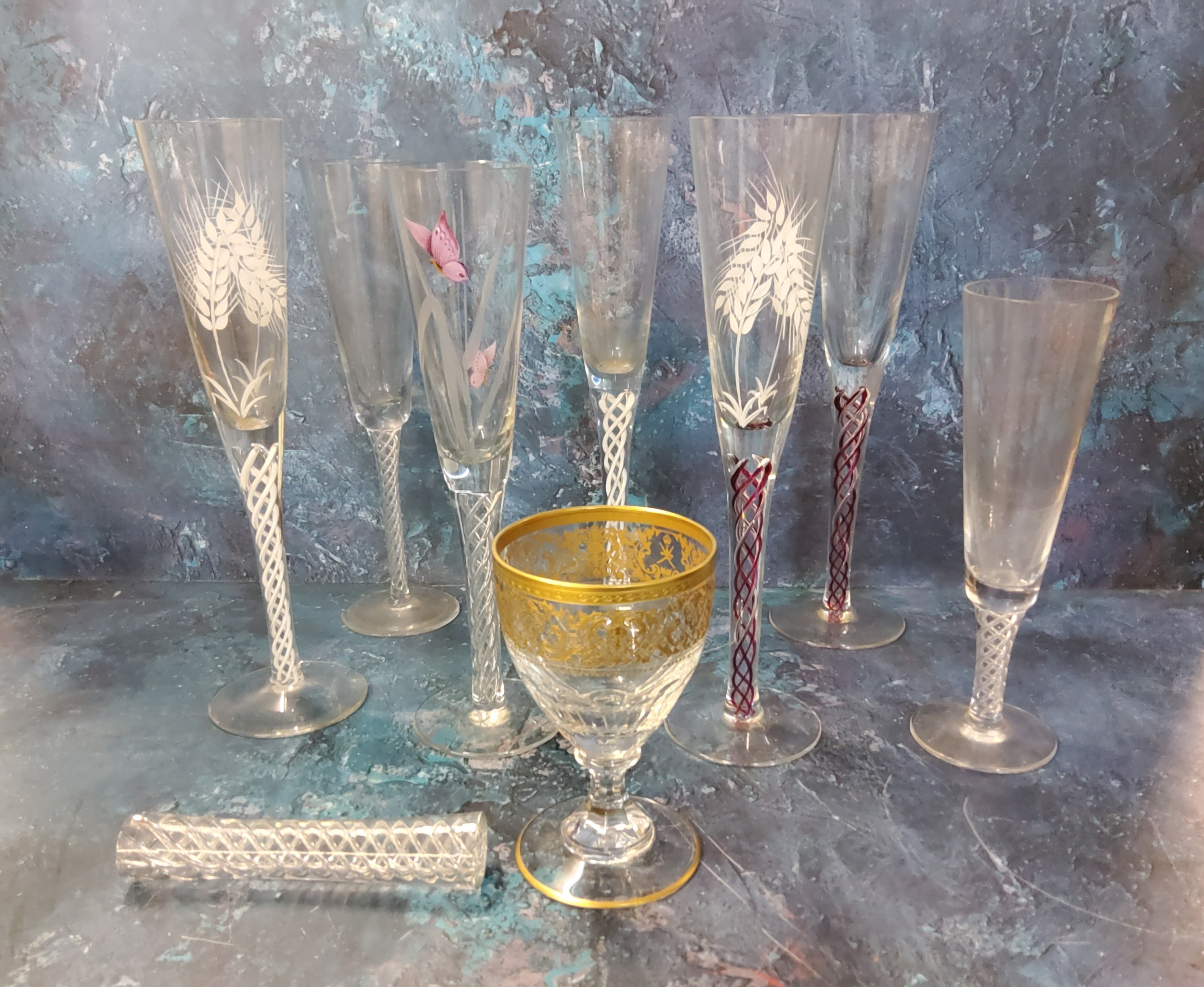 A champagne flutes, engraved and enamelled with butterfly and grasses, air twist stem, 27cm high;