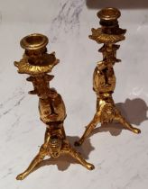 A pair of novelty giltwood candlesticks, as acrobats, 27cm high