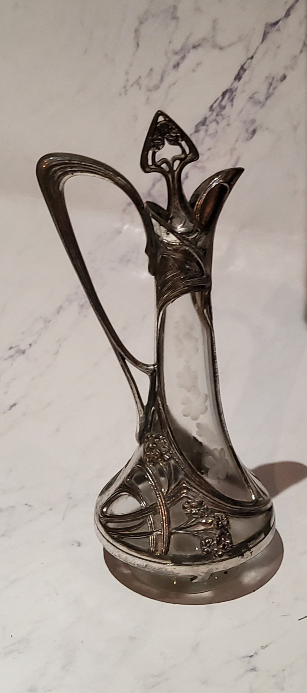 A W.M.F. liqueur decanter, applied with sinuous lines and foliage, 25cm high, c.1910